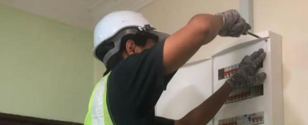 Electrician working at a distribution board